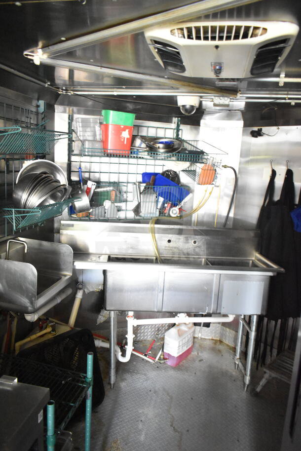 2020 LGS TX 8.5'x24' food trailer interior with CaptiveAire grease hood, stainless steel sink, and storage space.