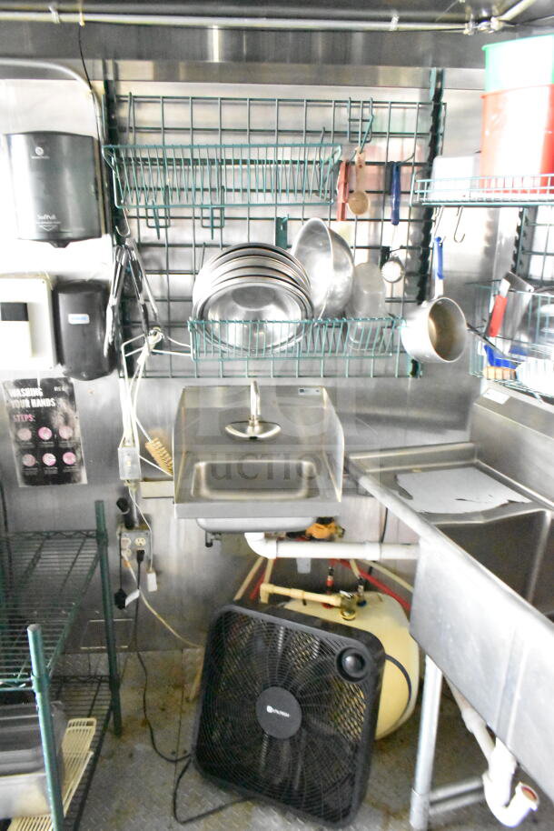 Interior of 2020 LGS TX food trailer featuring shelving, stainless steel sink, kitchen tools, and ventilation system.