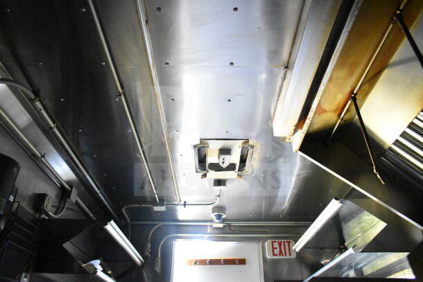 Interior of 2020 LGS TX 8.5'x24' food trailer, showing a CaptiveAire grease hood, suppression system, and ventilation.
