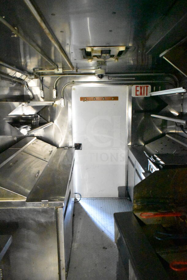 2020 LGS TX 8.5'x24' food trailer interior with CaptiveAire hood, suppression system, refrigeration, and griddle.
