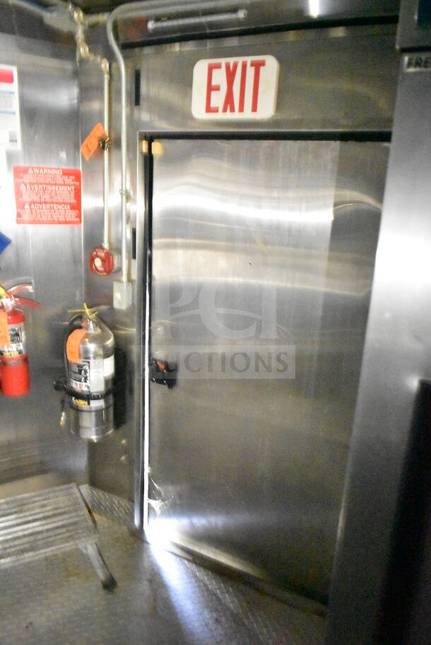 2020 LGS TX 8.5'x24' food trailer interior, CaptiveAire grease hood, fire suppression system, exit sign, and extinguisher shown.