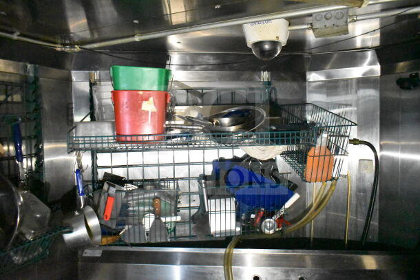 Interior view of 2020 LGS TX 8.5'x24' food trailer showing wire shelving with buckets, utensils, and cleaning supplies.