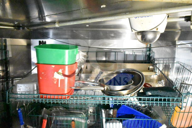 Interior of 2020 LGS TX food trailer with shelving holding kitchenware, cleaning supplies, and a security camera visible.