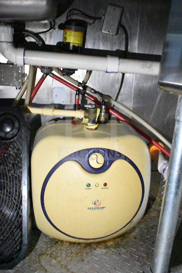 Inside view of 2020 LGS TX food trailer, featuring plumbing and an Eccotemp water heater, displaying power and heating indicators.