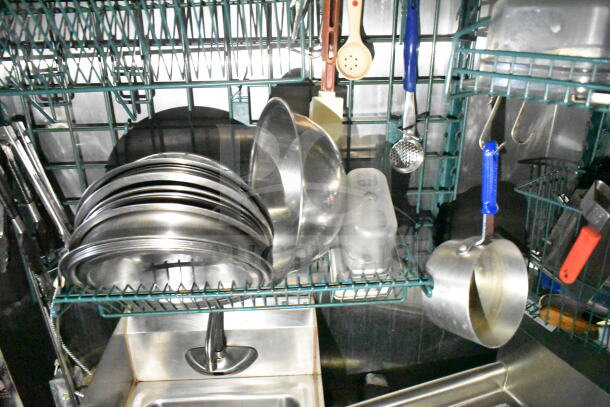 Interior of 2020 LGS TX 8.5'x24' food trailer with stainless steel kitchen utensils and sink.