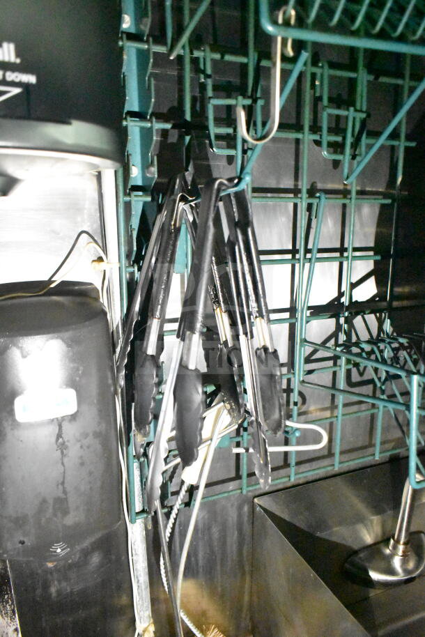 Interior of 2020 LGS TX food trailer, showing mounted kitchen tools and equipment storage.
