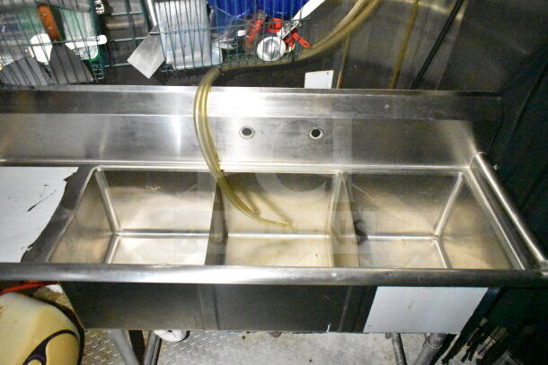 Three-compartment stainless steel sink inside a 2020 LGS TX 8.5'x24' food trailer. Part of the kitchen equipment.