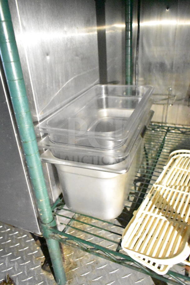 Interior view of 2020 LGS TX food trailer showing metal shelving with stackable food pans, part of kitchen setup.