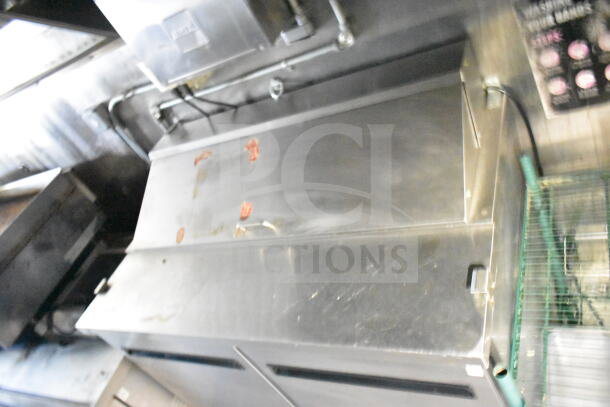2020 LGS TX 8.5'x24' food trailer interior; features CaptiveAire grease hood, refrigeration, and griddle.