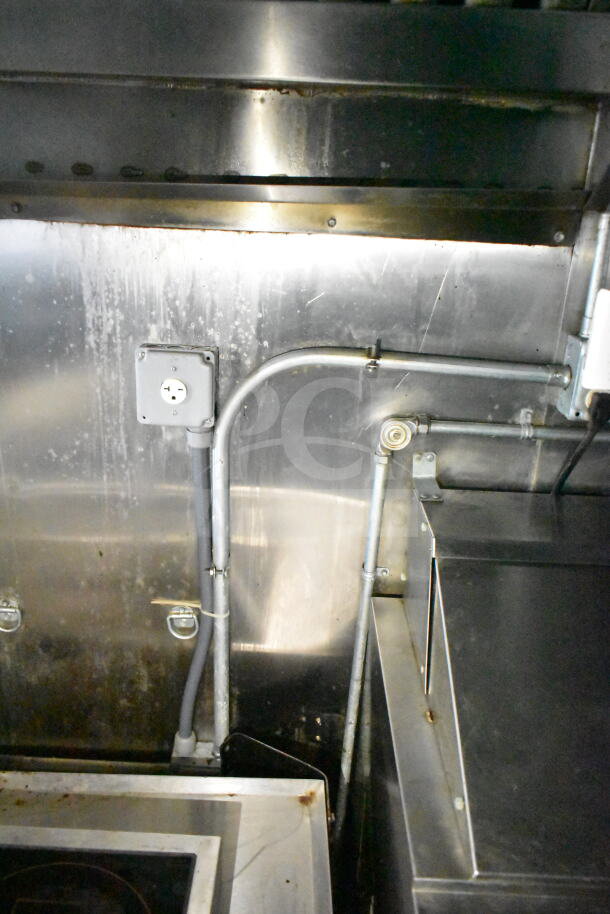 2020 LGS TX 8.5'x24' food trailer interior, showing stainless steel walls, CaptiveAire grease hood, and wiring.