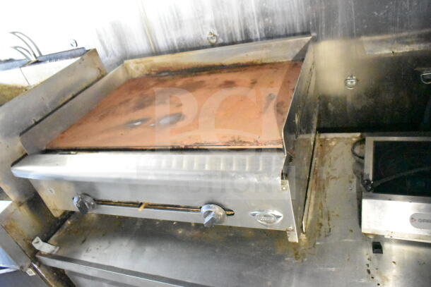 2020 LGS TX 8.5'x24' food trailer interior with griddle, CaptiveAire grease hood, and suppression system. Visible wear.