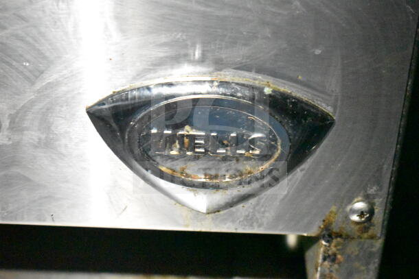 "Wells" logo on stainless steel surface of a kitchen appliance in the LGS TX 2020 food trailer.
