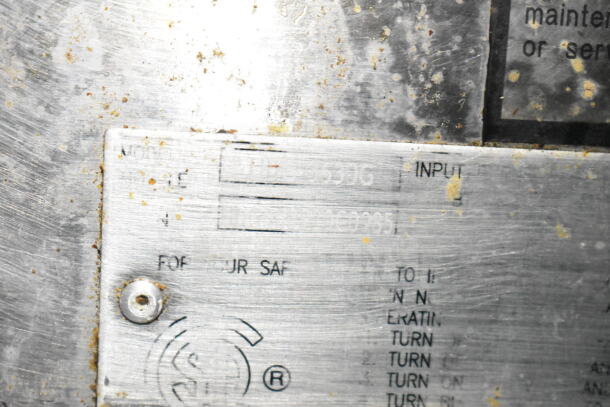 Close-up of a metal plate showing the VIN of a 2020 LGS TX Food Trailer, partially obscured, with visible wear and grime.