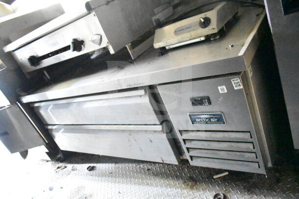2020 LGS TX 8.5'x24' food trailer interior with CaptiveAire grease hood, Arctic Air refrigerator, griddle, visible wear.