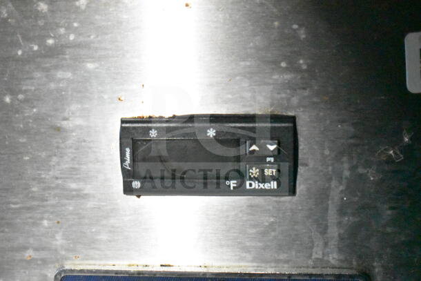 Dixell temperature control panel on LGS TX food trailer's refrigeration system. Buttons include cooling and setting options.