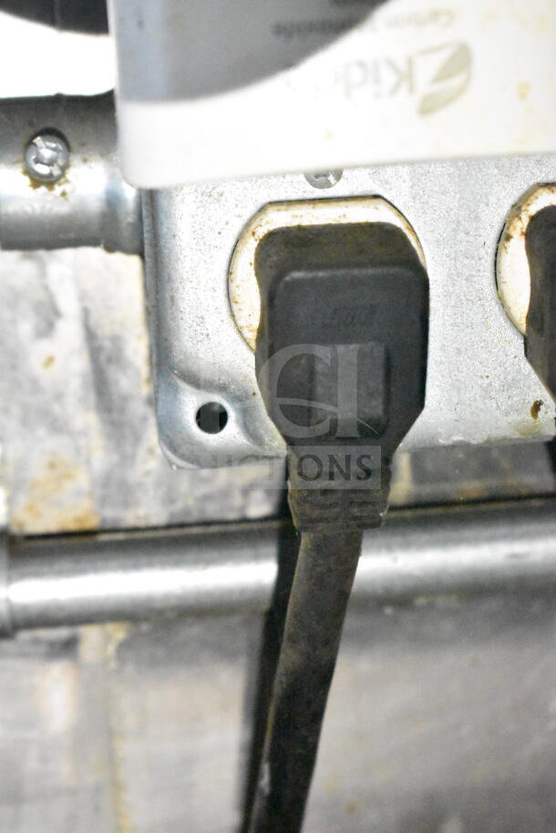 Close-up of an electrical plug inside a 2020 LGS TX food trailer, showcasing wiring and connection details.