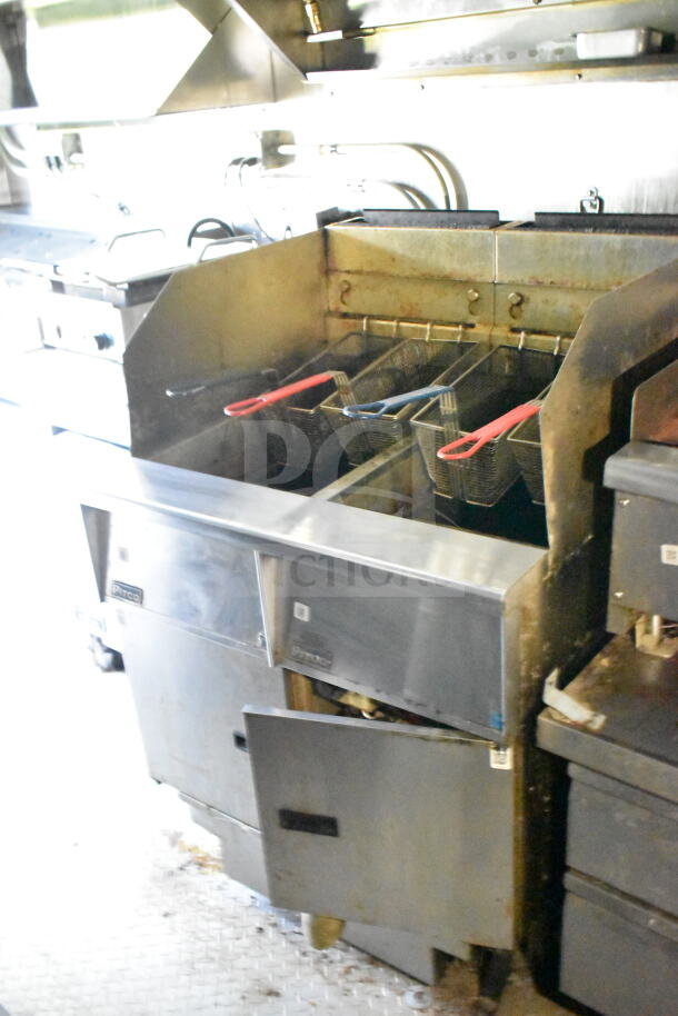 2020 LGS TX 8.5'x24' food trailer interior with CaptiveAire grease hood, fryer baskets, and cooking equipment visible.