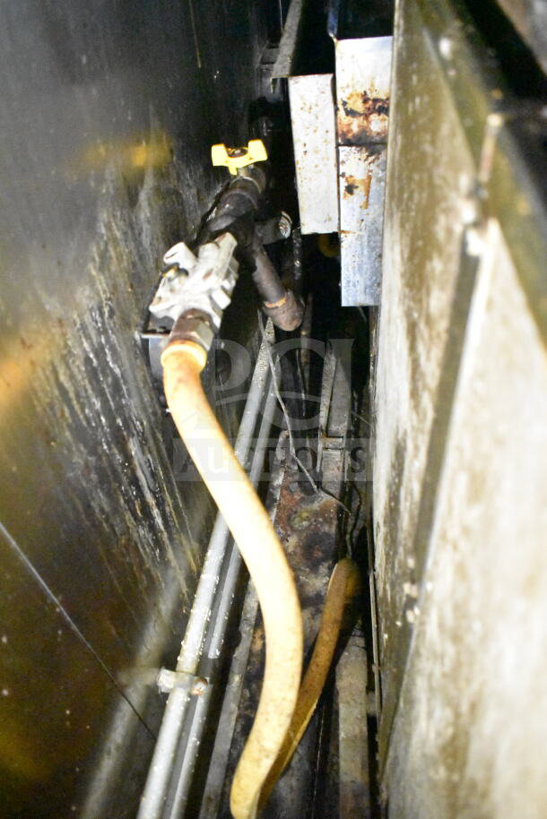 Inner view of 2020 LGS TX food trailer showing piping and grease hood system. Visible wear and grease buildup.