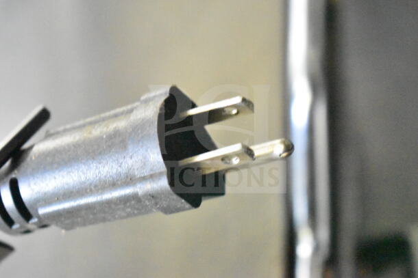 Close-up of a plug from a 2020 LGS TX 8.5'x24' food trailer. Black, three-prong design. Suitable for electrical use.