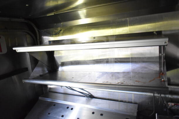 2020 LGS TX 8.5'x24' food trailer interior with stainless steel shelving. Equipped with CaptiveAire grease hood system.