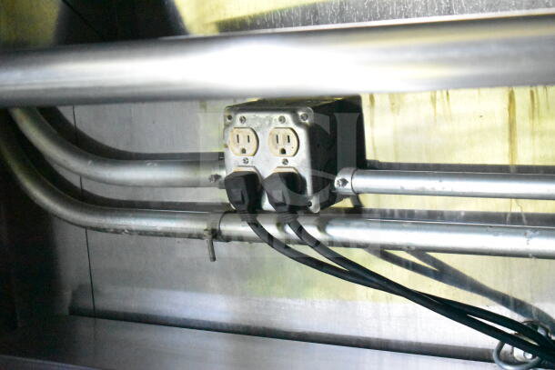 Electrical outlet with multiple cords in a 2020 LGS TX 8.5'x24' food trailer, featuring CaptiveAire grease hood system.