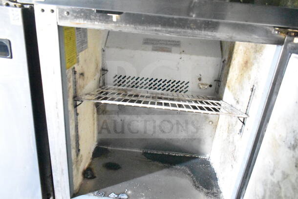 Interior of 2020 LGS TX food trailer, featuring shelving. Visible wear and signs of use on surfaces.