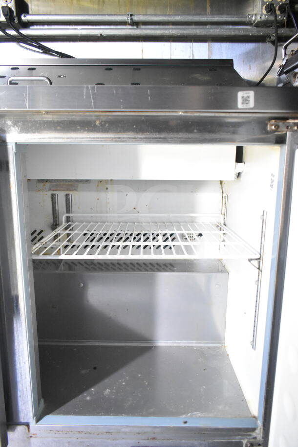 2020 LGS TX food trailer interior showing stainless steel refrigeration unit with wire shelf, inside view.
