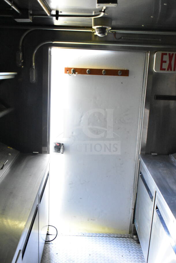 2020 LGS TX 8.5'x24' food trailer interior with stainless steel counters, CaptiveAire grease hood, and refrigeration units.
