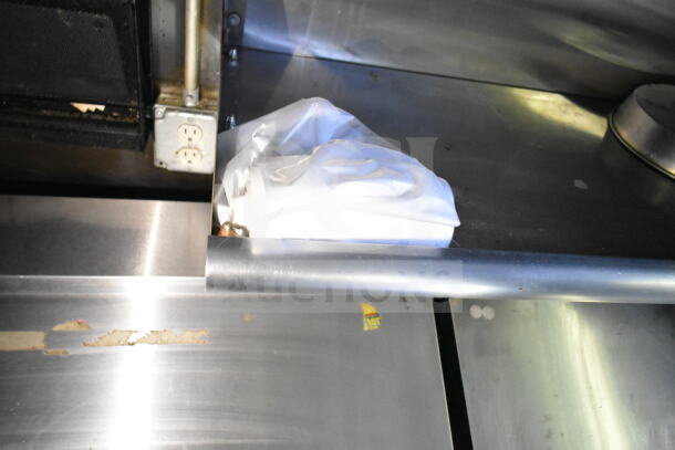 Inside view of 2020 LGS TX 8.5'x24' food trailer, showing CaptiveAire grease hood and stainless steel surfaces.