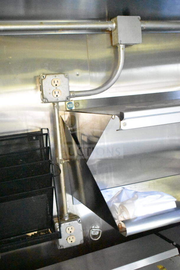 2020 LGS TX 8.5'x24' food trailer interior with CaptiveAire grease hood, refrigeration, griddle. NSF label visible.