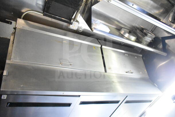 2020 LGS TX 8.5'x24' food trailer interior with CaptiveAire grease hood, suppression system, refrigeration, and griddle.
