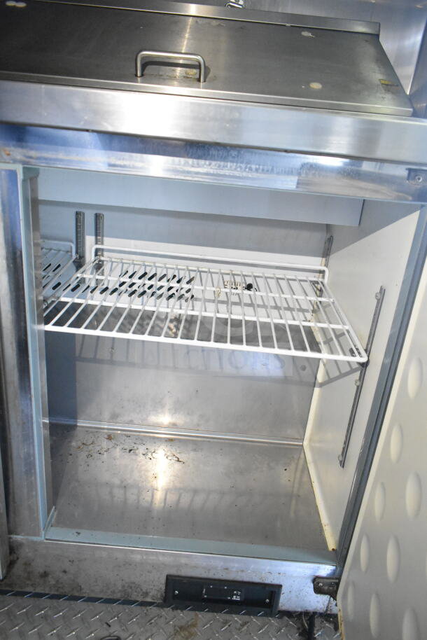Interior view of 2020 LGS TX food trailer with shelving. Includes stainless steel CaptiveAire grease hood system.