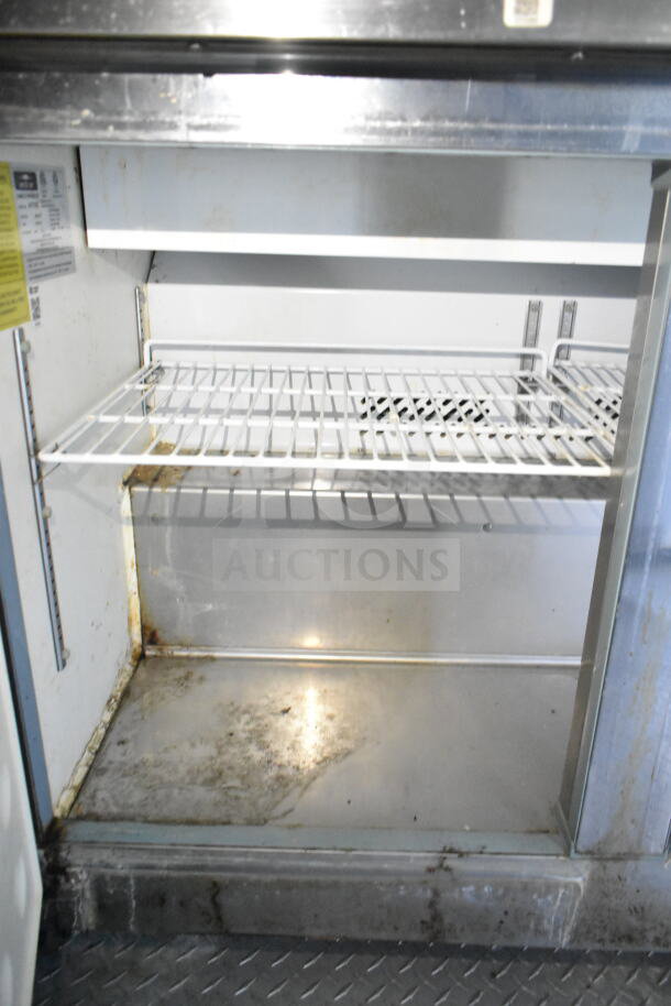 2020 LGS TX food trailer interior with worn refrigeration unit, showing wire shelving and metal surfaces with signs of use.
