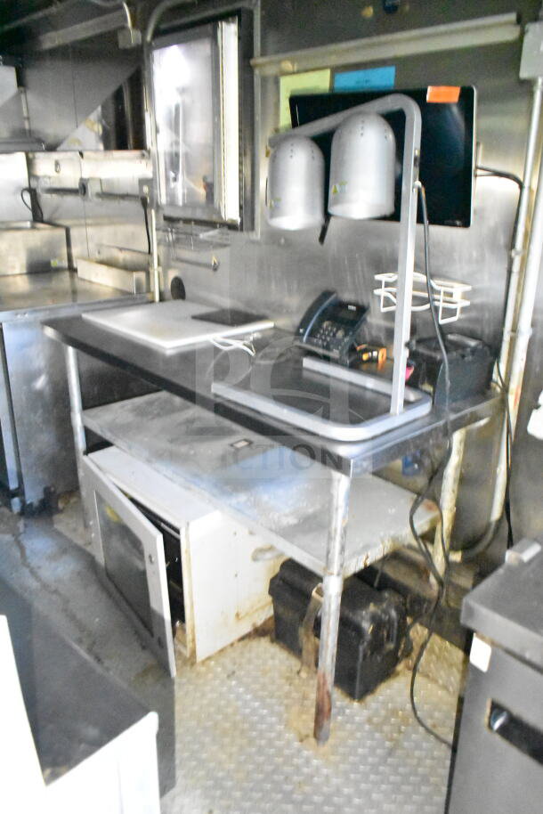 2020 LGS TX 8.5'x24' food trailer interior with worktable, CaptiveAire grease hood, suppression system, and refrigeration unit.