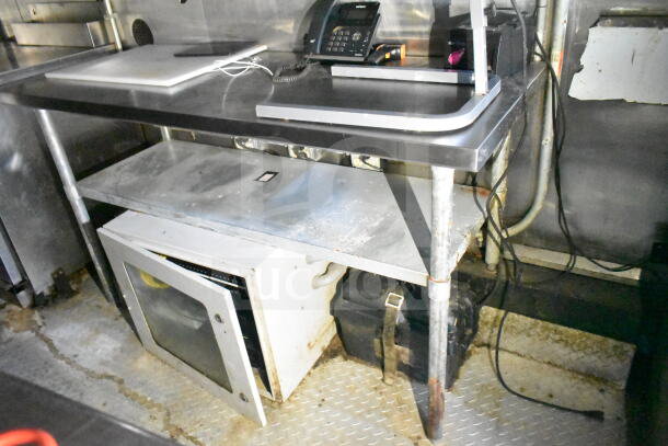 2020 LGS TX 8.5'x24' food trailer interior, featuring stainless steel counters, storage, and refrigeration.