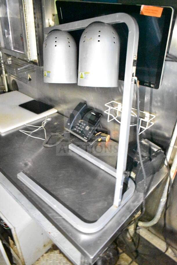 2020 LGS TX 8.5'x24' food trailer interior with CaptiveAire grease hood, phone, cooktop, and equipment on metal counter.