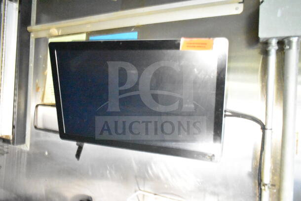 Interior view of a 2020 LGS TX 8.5'x24' food trailer featuring a mounted screen with visible cabling and metal wall panels.