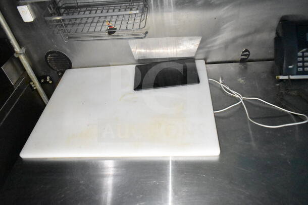 2020 LGS TX food trailer interior showing cutting board, wire shelf, and electrical cords on a stainless steel surface.
