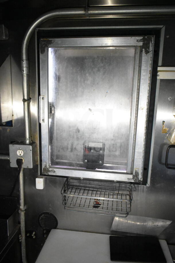 2020 LGS TX food trailer interior showing stainless steel surfaces, electrical panel, and a mounted basket.