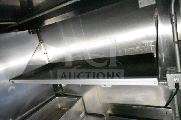Interior view of 2020 LGS TX food trailer, showing stainless steel CaptiveAire grease hood and suppression system.