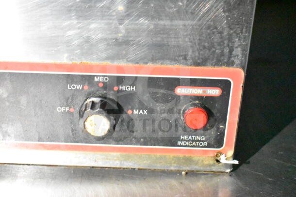 Close-up of a control panel on a 2020 LGS TX food trailer, showing heat settings and a caution label.