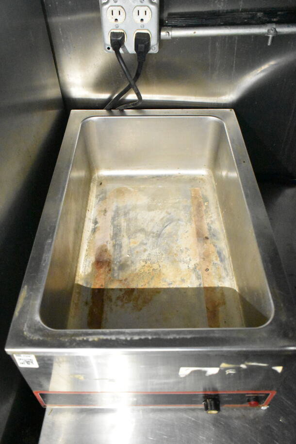 Stainless steel warming tray inside 2020 LGS TX food trailer with power outlets above. Tray shows signs of use.