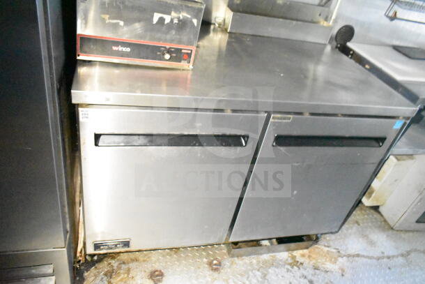 2020 LGS TX 8.5'x24' food trailer interior showing stainless steel refrigeration unit, Winco warmer, good condition.