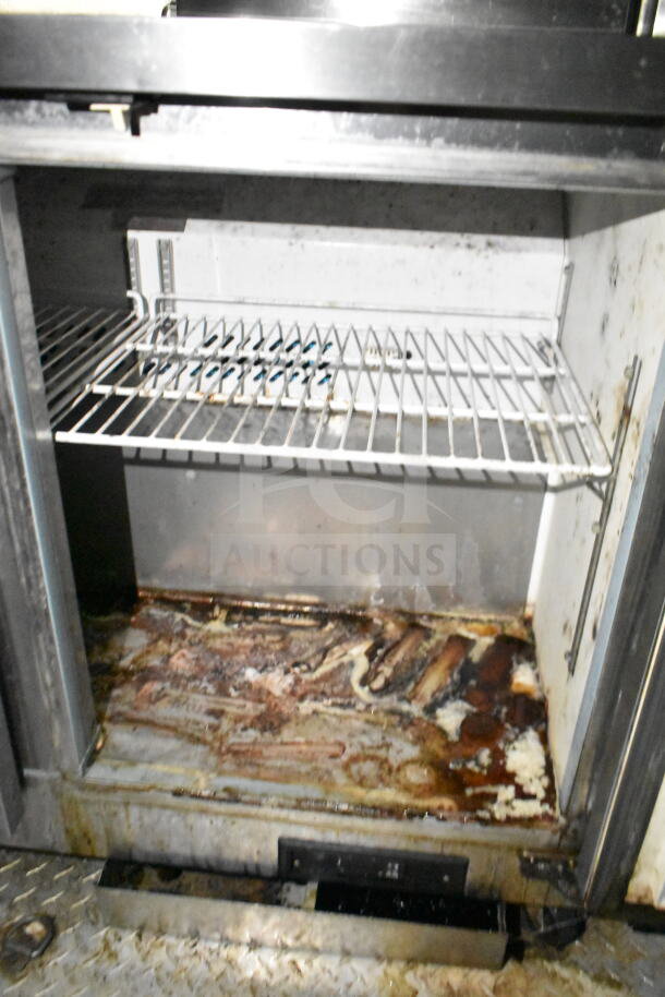 2020 LGS TX 8.5'x24' food trailer interior showing a metal shelf and dirty floor area, part of refrigeration unit.