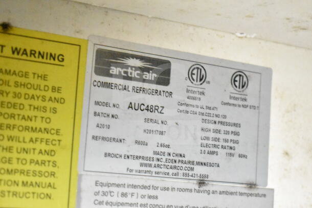 Arctic Air commercial refrigerator model AUC48RZ label, showing design pressures, batch number A2010, and serial number H20117087.