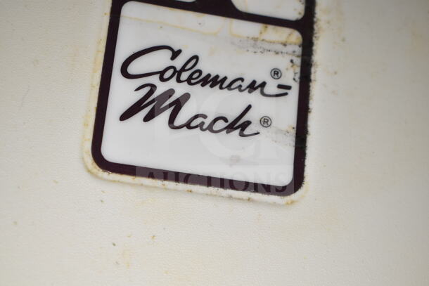 "Close-up of Coleman-Mach label on a 2020 LGS TX 8.5'x24' food trailer featuring grease hood, refrigeration, and griddle."