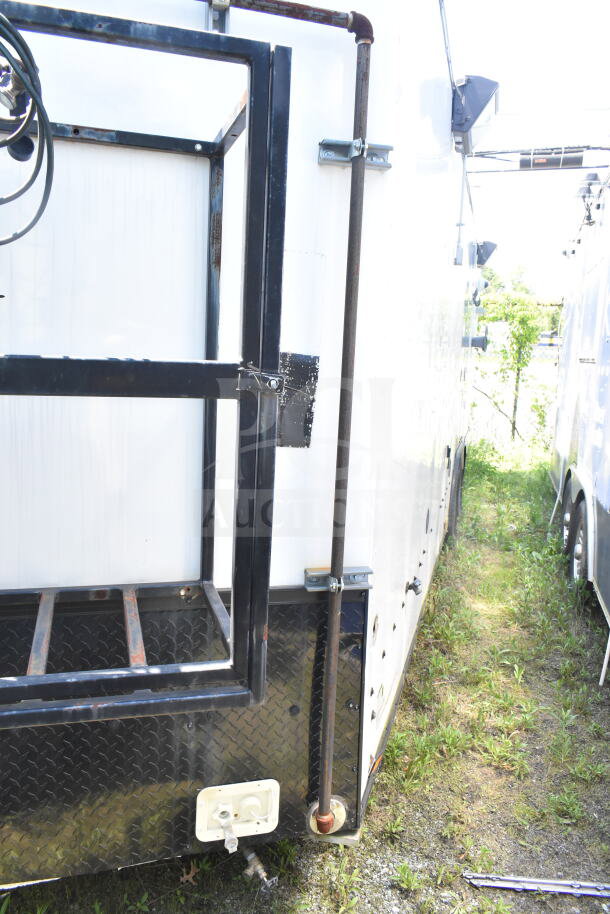 2020 LGS TX 8.5'x24' food trailer side view, metal frame, visible piping, potential rust on the frame.
