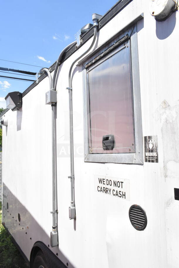 2020 LGS TX 8.5'x24' food trailer with window and security sign. White exterior, CaptiveAire hood, suppression system.