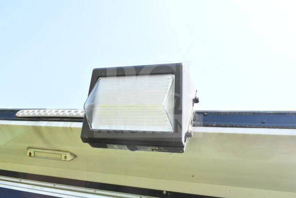 Close-up of a mounted light on the 2020 LGS TX 8.5'x24' food trailer. Light is rectangular with a clear lens.