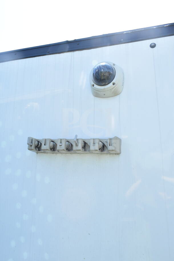 Outdoor view of 2020 LGS TX 8.5'x24' food trailer. Features visible include a security camera and exterior fixtures.